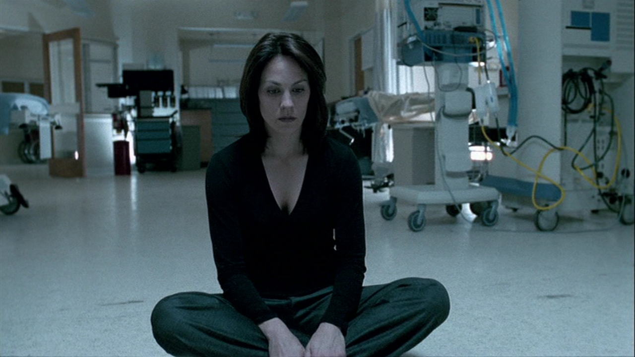 annabeth gish monica reyes sitting on a floor x-files