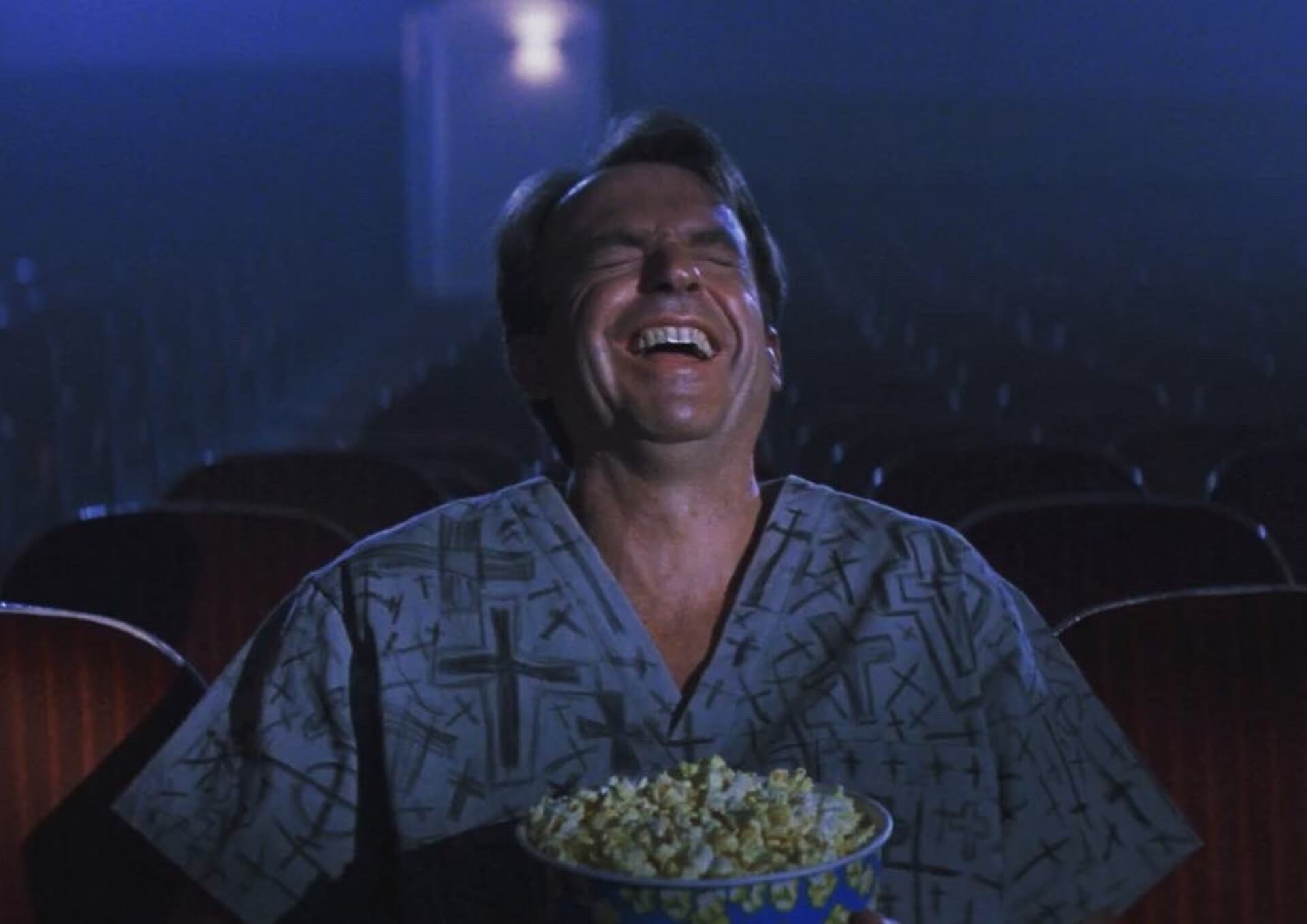 in the mouth of madness sam neill laughing his ass off in a cinema