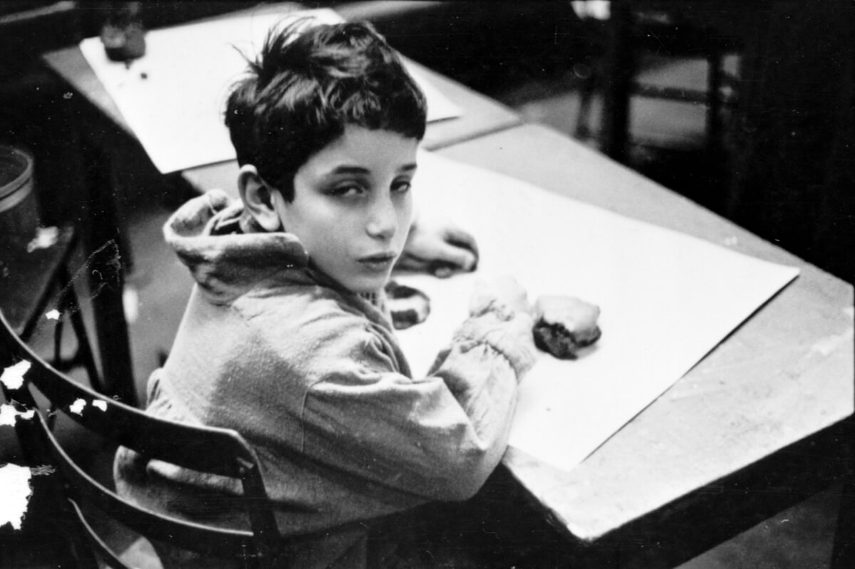 Stanley Kubrick as a boy in a classroom
